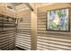 Convenient outdoor shower with built-in shelves and stained glass at 1111 Summerwind Lane, Seabrook Island, SC 29455