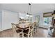 Dining room with a wood table and chairs, offering a view of the kitchen and backyard at 1111 Summerwind Lane, Seabrook Island, SC 29455