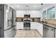 Modern kitchen with stainless steel appliances and white cabinetry at 1111 Summerwind Lane, Seabrook Island, SC 29455