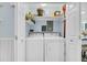 Convenient laundry room with washer, dryer, and shelving for storage at 1111 Summerwind Lane, Seabrook Island, SC 29455