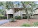 Exterior view of a charming two-story house with lush landscaping at 1111 Summerwind Lane, Seabrook Island, SC 29455