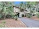 Exterior view of a charming two-story house with lush landscaping and a driveway at 1111 Summerwind Lane, Seabrook Island, SC 29455