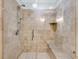 Large tiled shower with glass enclosure and built-in seat at 1111 Summerwind Lane, Seabrook Island, SC 29455