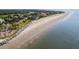 Aerial view of wide sandy beach with ocean and homes at 1111 Summerwind Lane, Seabrook Island, SC 29455