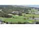 Aerial view showcasing a golf course and luxurious homes nestled in a verdant landscape at 1111 Summerwind Lane, Seabrook Island, SC 29455
