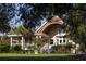 Charming two-story home with wrap-around porch and lush landscaping at 1111 Summerwind Lane, Seabrook Island, SC 29455