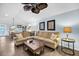 Living room with sectional sofa, wood coffee table, and ceiling fan at 1111 Summerwind Lane, Seabrook Island, SC 29455