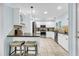 Modern kitchen with stainless steel appliances, white cabinets, and a breakfast bar at 1111 Summerwind Lane, Seabrook Island, SC 29455