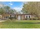 Brick ranch home with a covered porch, mature landscaping, and a large yard at 101 Robin Ct, Summerville, SC 29485