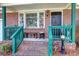 Brick front porch with teal railings and decor at 925 Center St, Mount Pleasant, SC 29464