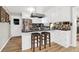 Kitchen boasts white cabinets, granite countertops, and breakfast bar with two stools at 925 Center St, Mount Pleasant, SC 29464