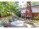 Brick patio with metal furniture, surrounded by lush greenery at 925 Center St, Mount Pleasant, SC 29464