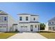 Two-story white house with gray accents, two-car garage, and a landscaped lawn at 343 Chapman Cir, Goose Creek, SC 29445