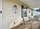 Front porch with two chairs and decorative wall art at 1307 Aubry Dr, Moncks Corner, SC 29461