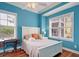 Serene bedroom with light blue walls, a queen bed, and hardwood floors at 204 Michigan Ave # D2, Folly Beach, SC 29439