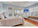 Main bedroom with light blue walls, king bed and water views at 204 Michigan Ave # D2, Folly Beach, SC 29439