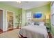Bedroom with green walls, queen bed, and en-suite bathroom at 204 Michigan Ave # D2, Folly Beach, SC 29439