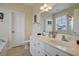 Double vanity bathroom with white cabinets and a bathtub at 204 Michigan Ave # D2, Folly Beach, SC 29439