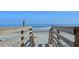 Wooden steps leading to sandy beach at 204 Michigan Ave # D2, Folly Beach, SC 29439
