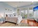 Main bedroom with light blue walls, king bed and water views at 204 Michigan Ave # D2, Folly Beach, SC 29439