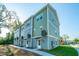 Side view of three story townhomes showcasing modern design and landscaping at 211 Cache Ct # 6, Charleston, SC 29414