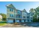 Three-story townhomes with attached garages and neutral-toned siding at 211 Cache Ct # 6, Charleston, SC 29414