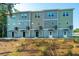 Rear view of three story townhomes with private entrances and outdoor space at 211 Cache Ct # 6, Charleston, SC 29414