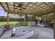 Relaxing patio space with covered seating and a large TV at 443 Lazy Hill Rd, Moncks Corner, SC 29461