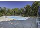 Clean and refreshing in-ground pool, surrounded by lush landscaping at 443 Lazy Hill Rd, Moncks Corner, SC 29461
