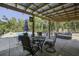 Covered patio with seating and dining areas near pool at 443 Lazy Hill Rd, Moncks Corner, SC 29461