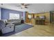 Open concept kitchen and living area with hardwood floors, stainless steel appliances, and island at 443 Lazy Hill Rd, Moncks Corner, SC 29461