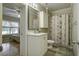 Clean bathroom with white vanity, shower, and decorative curtain at 443 Lazy Hill Rd, Moncks Corner, SC 29461