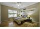 Bright bedroom with hardwood floors, window, ceiling fan and built-in shelves at 443 Lazy Hill Rd, Moncks Corner, SC 29461