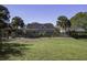 House backyard with a large grassy area and a fenced-in pool area at 443 Lazy Hill Rd, Moncks Corner, SC 29461