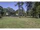 Large backyard with a home, fenced pool, and mature trees providing shade at 443 Lazy Hill Rd, Moncks Corner, SC 29461