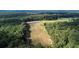 High-angle view of a long harvested cornfield nestled within a wooded area at 0 Tuten Road, Round O, SC 29474