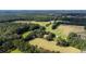 Aerial view of a farmhouse nestled in vast farmland at 0 Tuten Road, Round O, SC 29474