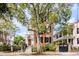 Brick home with three stories, front porch, and large tree at 52 Hasell St, Charleston, SC 29401