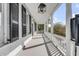 Spacious front porch with white columns and black shutters at 52 Hasell St, Charleston, SC 29401