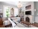 Spacious living room with sectional sofa, fireplace, and hardwood floors at 1 Wall St, Charleston, SC 29401