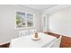 Bright dining room with hardwood floors, white table, and four chairs at 180 Cherry Grove Dr, Summerville, SC 29483