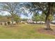 Landscaped front yard with large trees and a gated entrance at 3915 Ladson Rd, Ladson, SC 29456