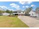 Two-story house with brick and white siding, screened porch, and detached garage at 3915 Ladson Rd, Ladson, SC 29456