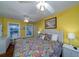 Main bedroom with king-size bed and yellow walls at 2302 Palmetto Blvd, Edisto Beach, SC 29438