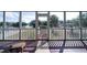 Relaxing screened porch with wooden flooring and backyard view at 2302 Palmetto Blvd, Edisto Beach, SC 29438