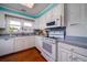 Bright kitchen with white cabinets, wood floors, and modern appliances at 2302 Palmetto Blvd, Edisto Beach, SC 29438