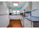 Bright kitchen with white cabinets, wood floors, and modern appliances at 2302 Palmetto Blvd, Edisto Beach, SC 29438