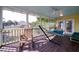 Screened porch with a hammock, rocking chair, and access to the backyard at 2302 Palmetto Blvd, Edisto Beach, SC 29438