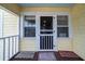 Quaint front porch with screen door and access to the interior of the home at 2302 Palmetto Blvd, Edisto Beach, SC 29438