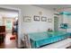 Bright dining area with white table and turquoise tablecloth, offering a view of a bedroom at 2302 Palmetto Blvd, Edisto Beach, SC 29438
